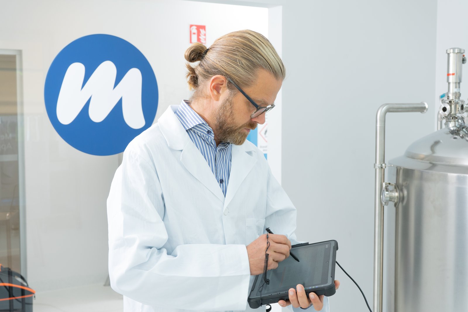 Man operating ipad in lab environment